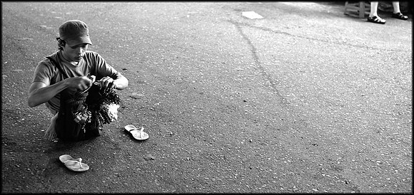 Trinket seller at market who used his hands as feet
