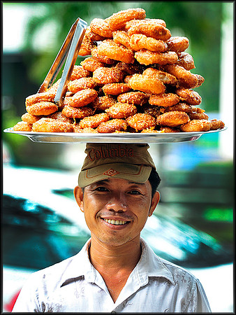 Sticky Pastry  seller poses on Tran Cao Van Street near Turtle Fountain