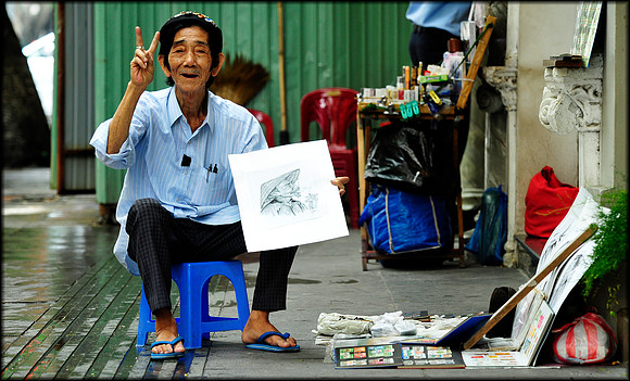 Mr Thai , an artist who has been selling his works on Dong Koi Street for over 58 years.