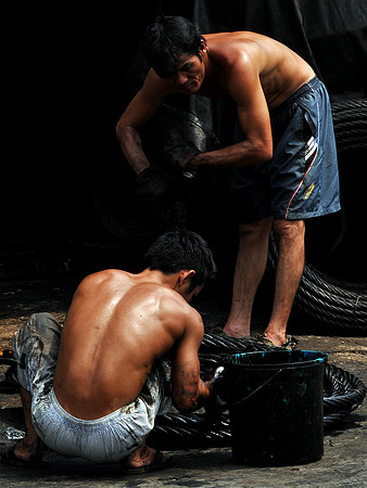 Men Oiling Steel Cables