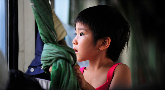 Young Girl Looking out Train Window